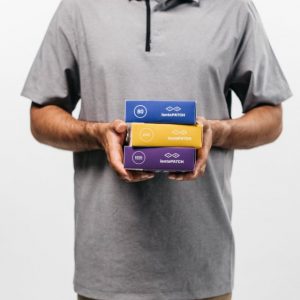 Man holding three products from Iontopatch: STAT, 80, and Extra Strength.