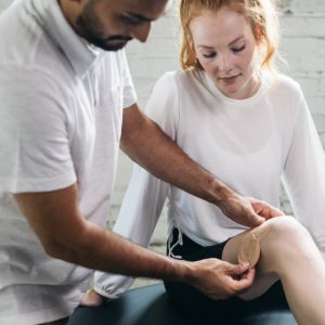 Physician placing IontoPatch on woman runners leg