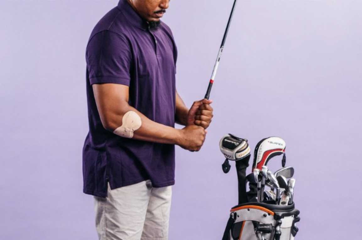 Male golfer holding club with IontoPatch on arm